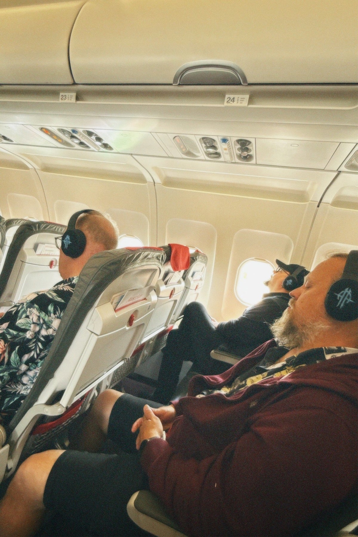 Sonata Arctica members wearing Valco headphones on an airplane
